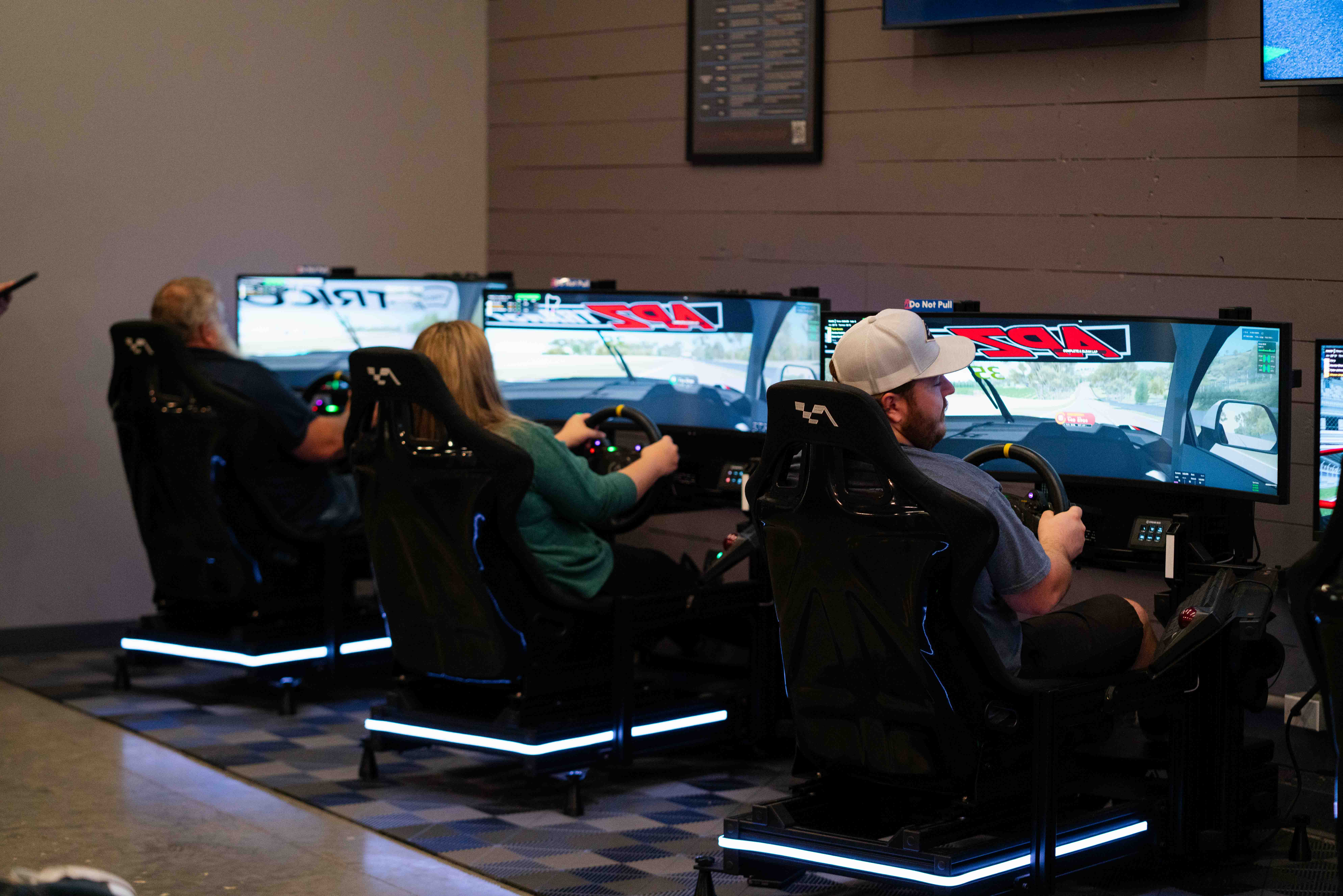 Multiple sim racing rigs in a row at Grid Lounge