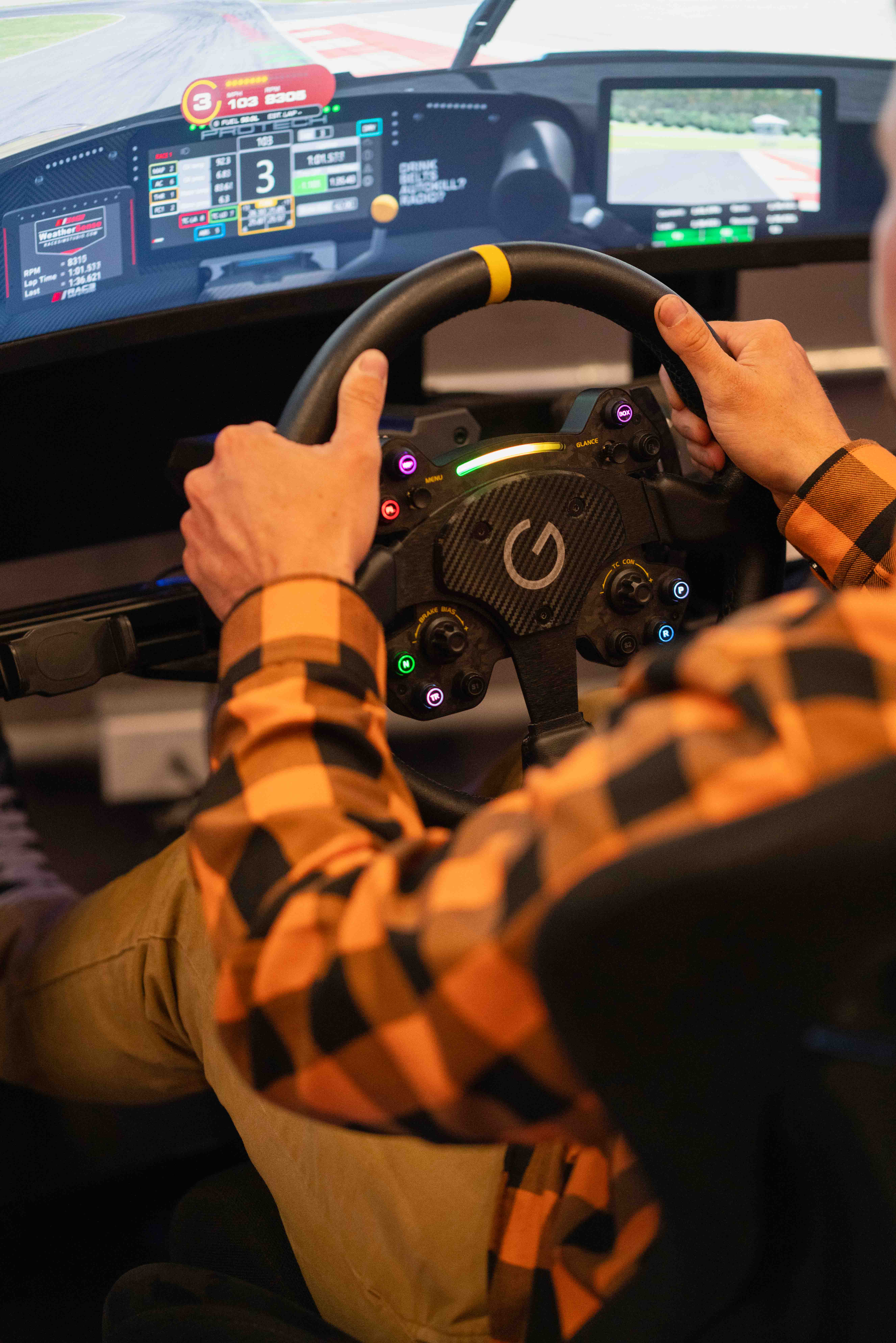 Close-up of hands on a sim racing steering wheel